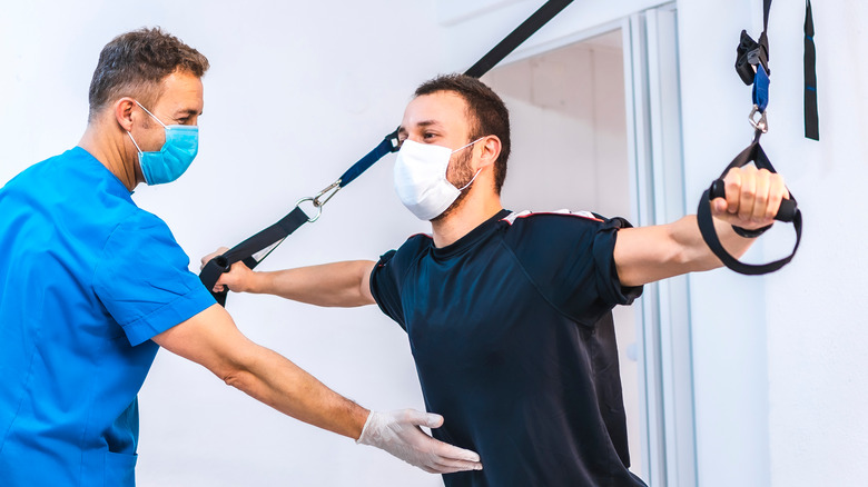 Man using suspension trainer