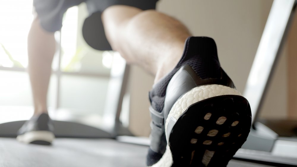 Close up of a mans foot on the treadmill 