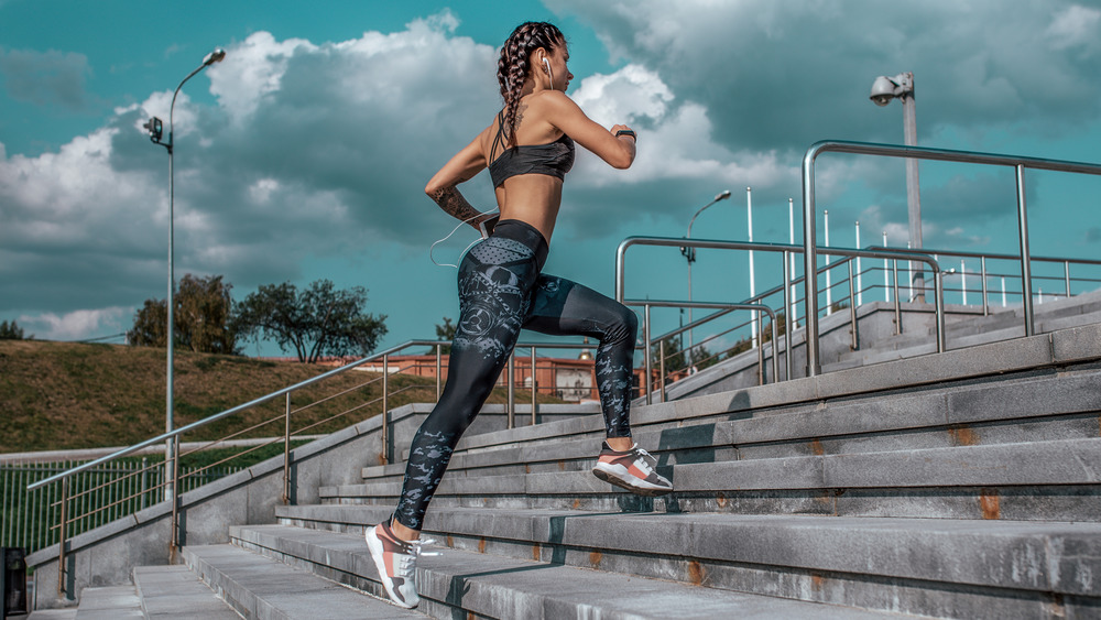 woman running up outdoor steps