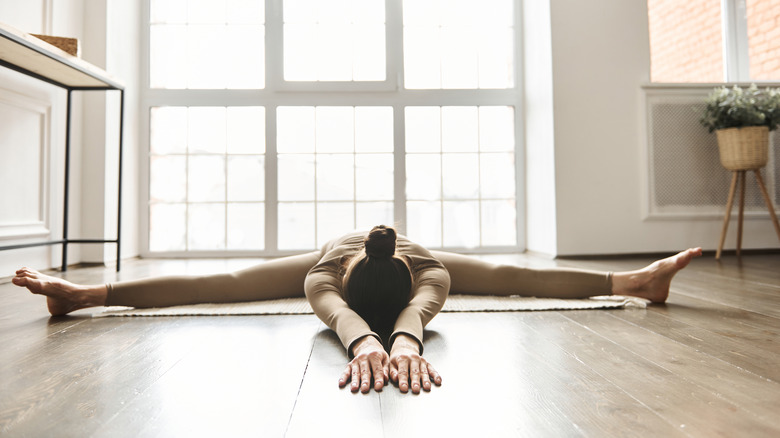 woman doing seated forward bend