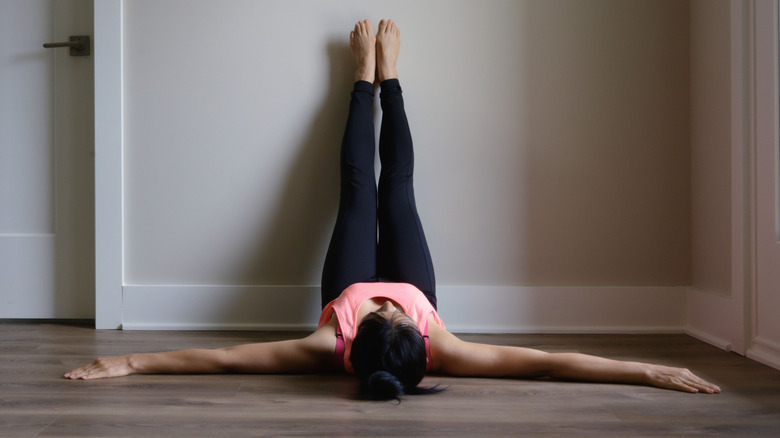 person doing legs-up-the-wall pose