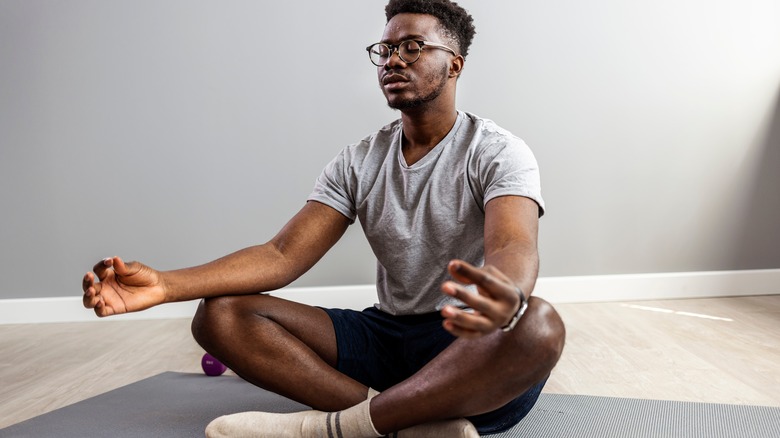 person sitting in meditation