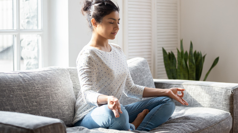 Woman meditating on couch