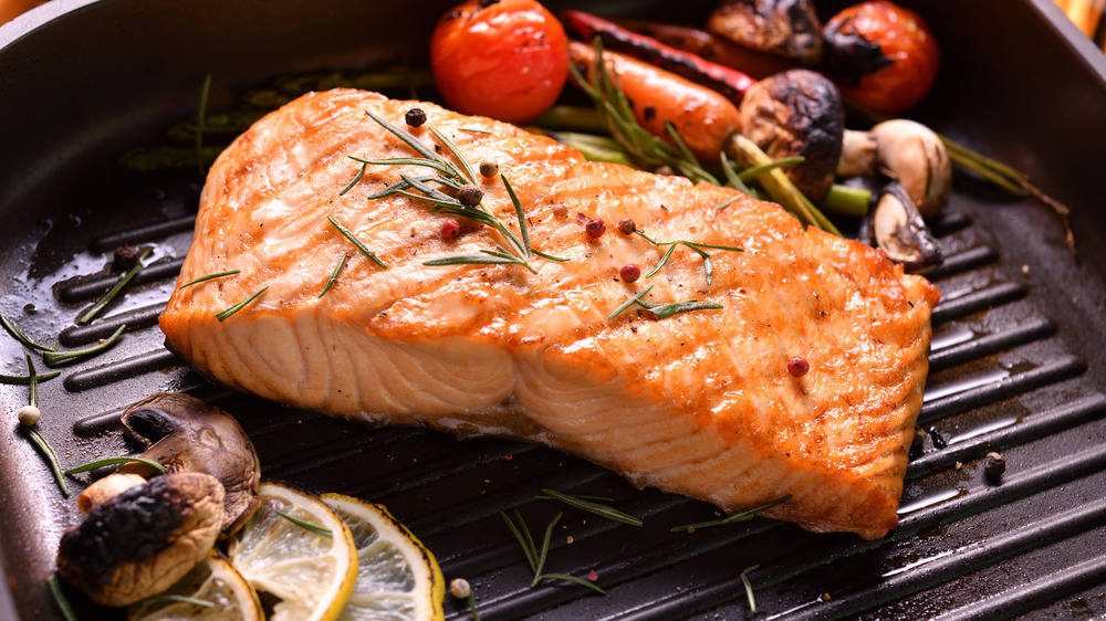 Grilled salmon cooking with vegetables