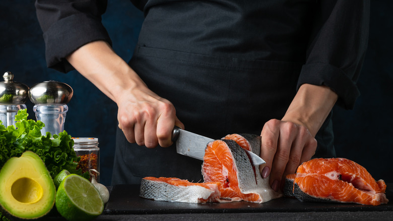 Person chopping salmon