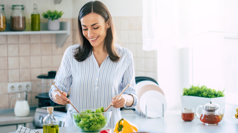 woman preparing a healthy salad in her kitchen