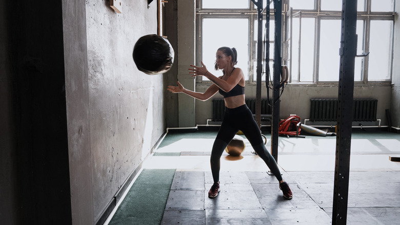Fit woman throwing a medicine ball