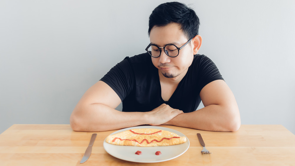 Man bored with breakfast