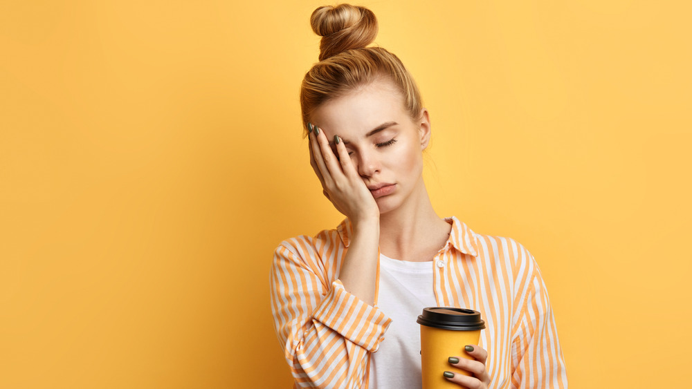 tired woman with coffee cup