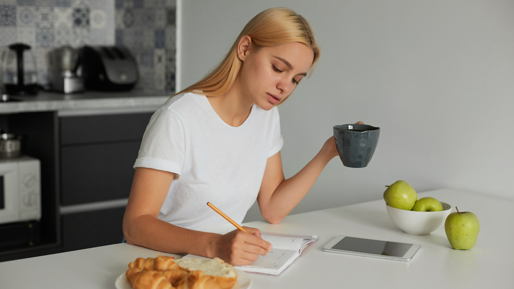 woman writing in notebook