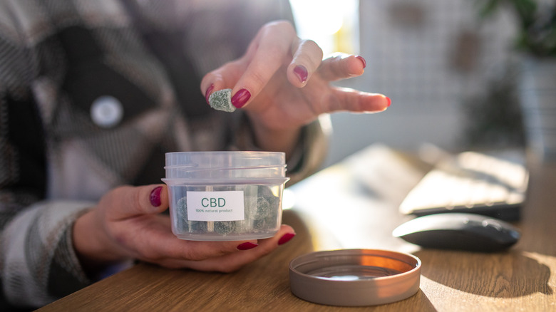 Hand holding CBD gummy