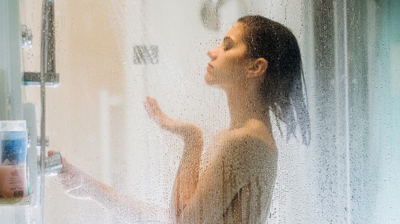 A woman showing in a hot shower 