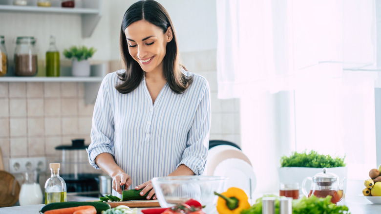 Woman cutting vegetables in the kitchen