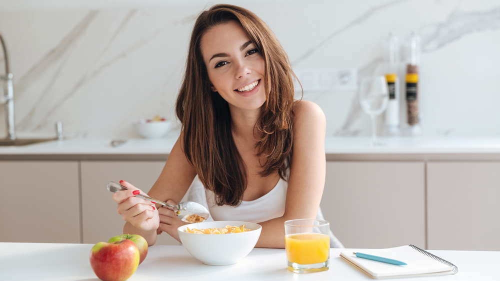 woman eating cereal for breakfast