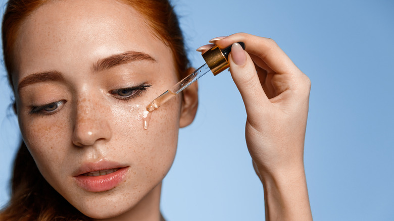 woman applying essential oils directly to her skin