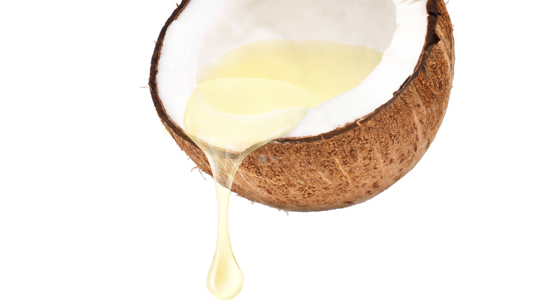 coconut oil spilling out of fresh coconut
