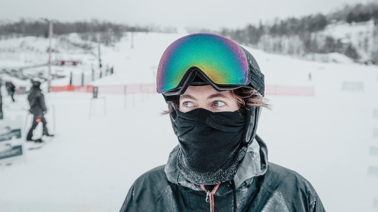 Medium photo of a woman bundled up on a cold day about to go skiing