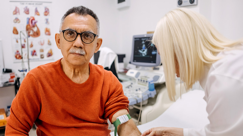 An older adult giving blood