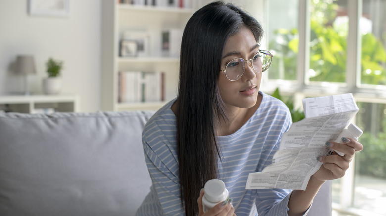 Woman reading dosage instructions