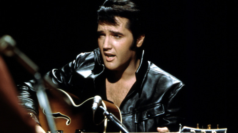 Elvis Presley singing and playing guitar