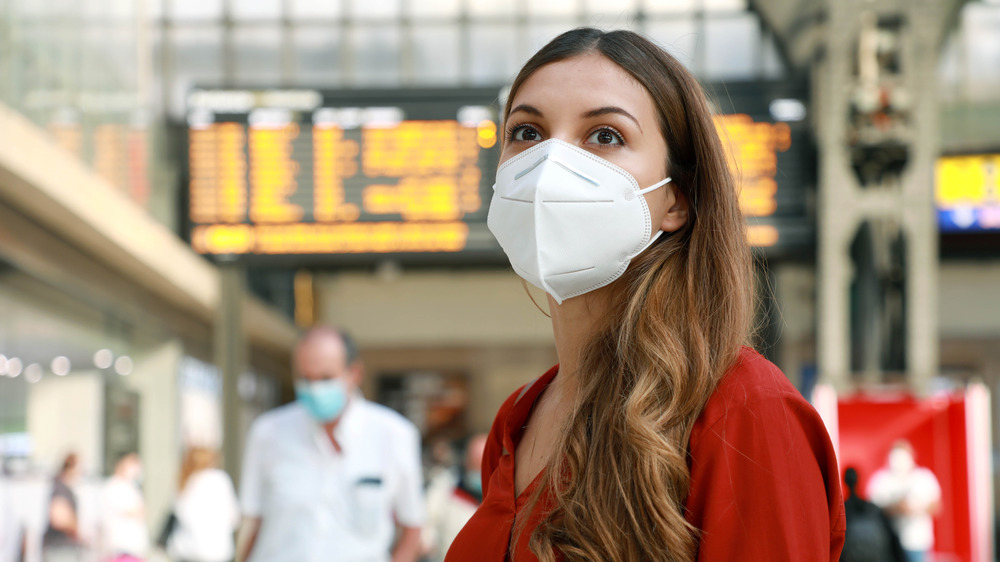 Woman wears a mask in an airport
