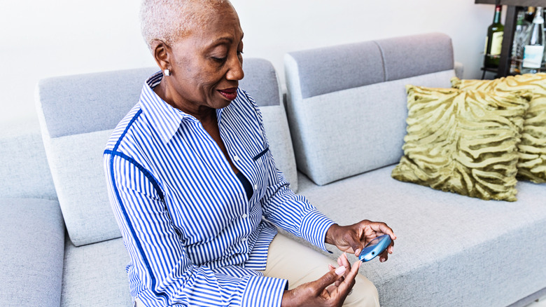 older woman checking her blood sugar