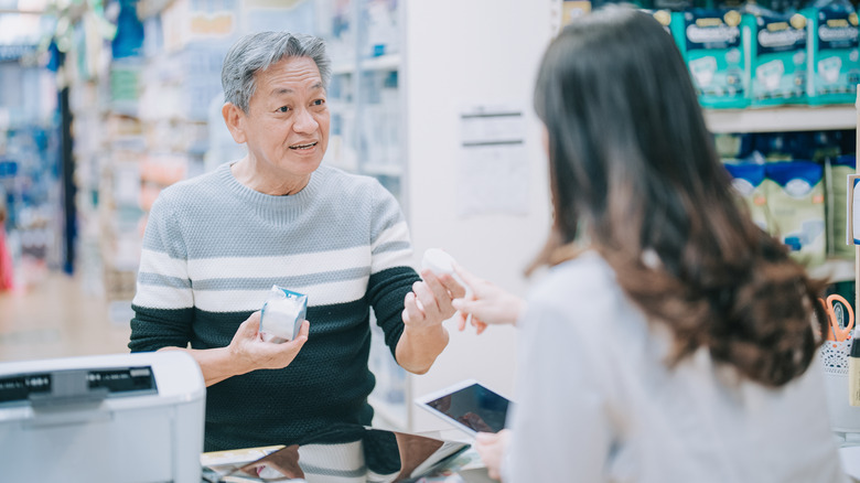 Man consulting with pharmacist