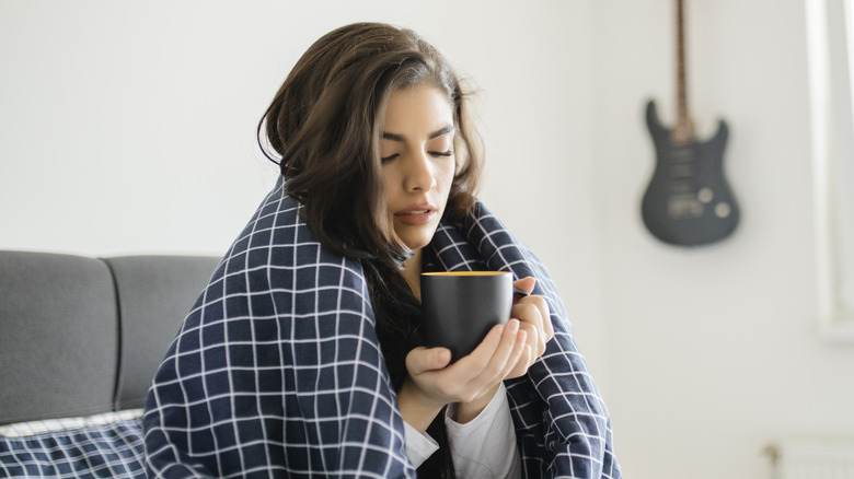 Woman having coffee when sick