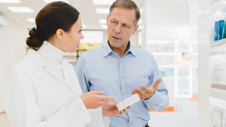 man speak with pharmacist about supplements