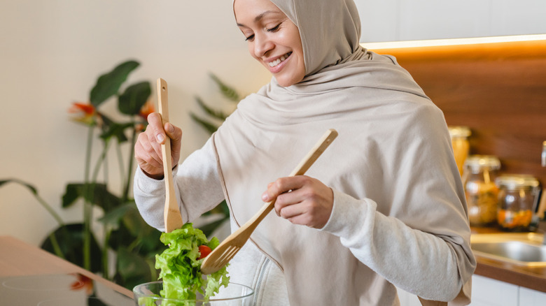 Woman in hijab preparing salad 