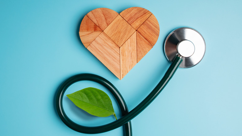 wooden heart, stethoscope, and leaf