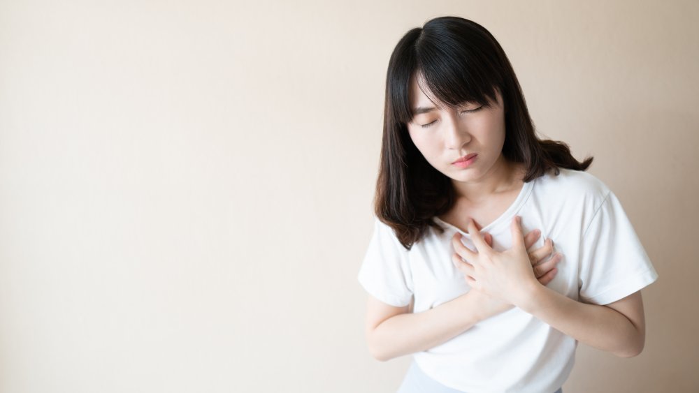 Woman holding chest