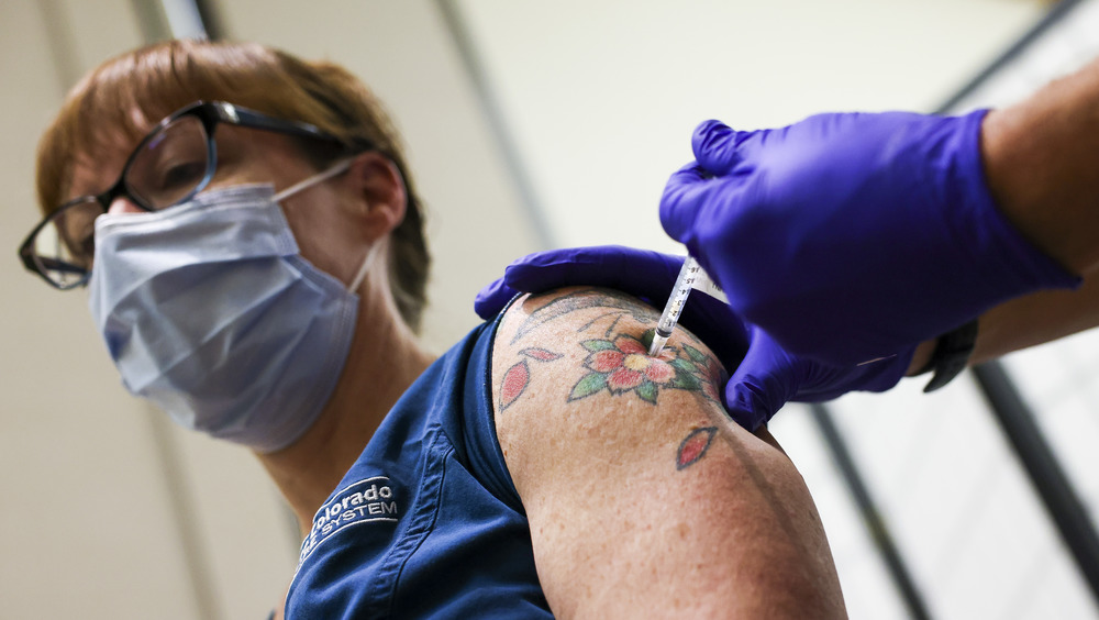 A Colorado ICU nurse receives the COVID-19 vaccine