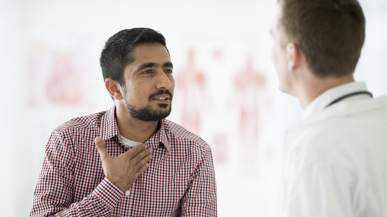 Man with chest pain talking to doctor