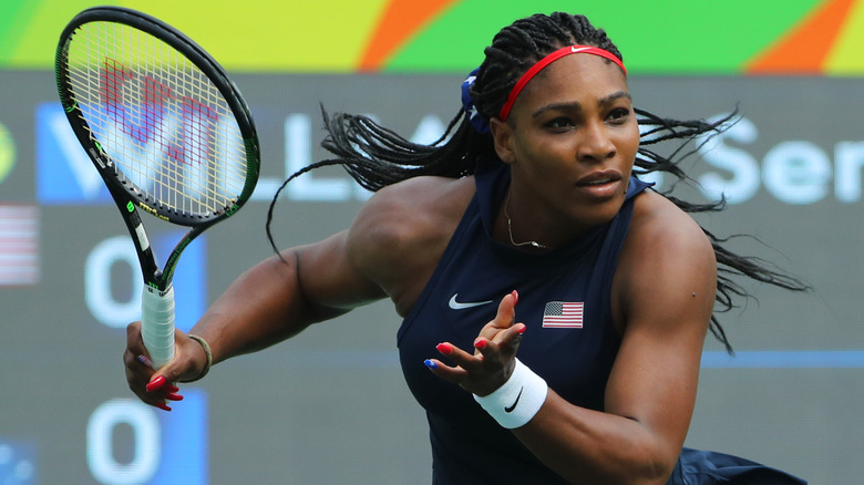 Serena Williams running with tennis racket