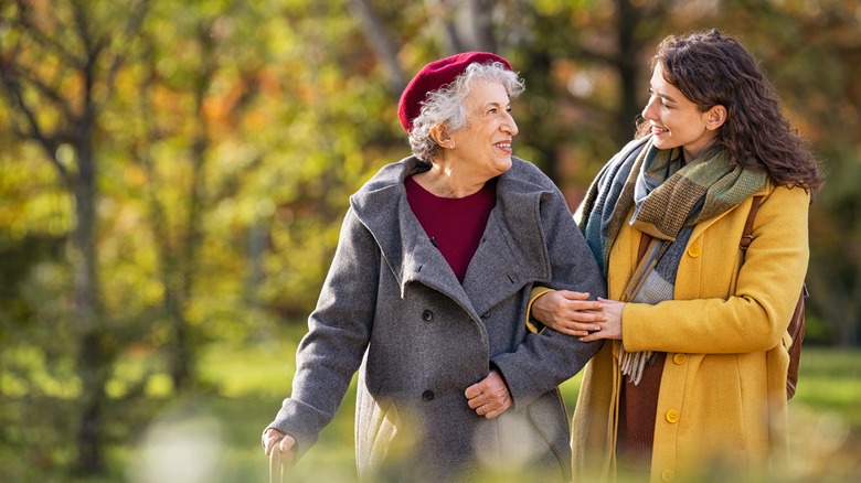 A woman takes her mother on a walk