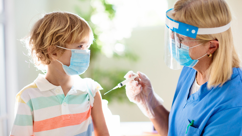 vaccine injection with little boy