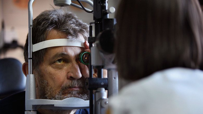A man has his vision checked at an eye appointment
