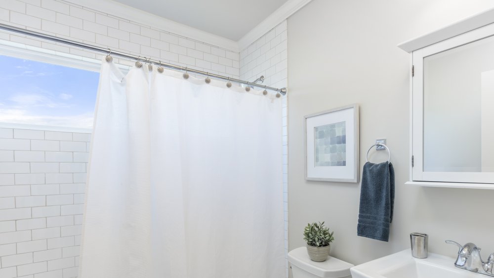 White shower curtain in bathroom