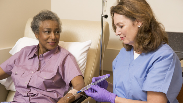 Patient receiving IV treatment from nurse