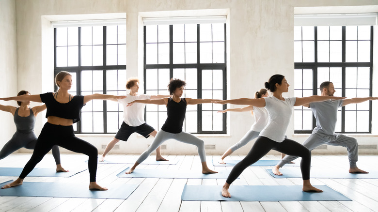 diverse people practicing yoga