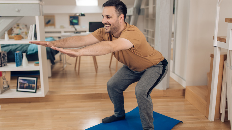 man doing bodyweight squats