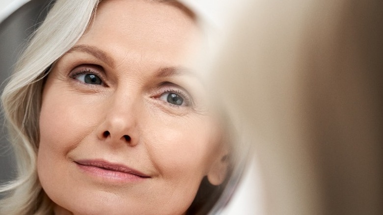 Older woman smiling in mirror