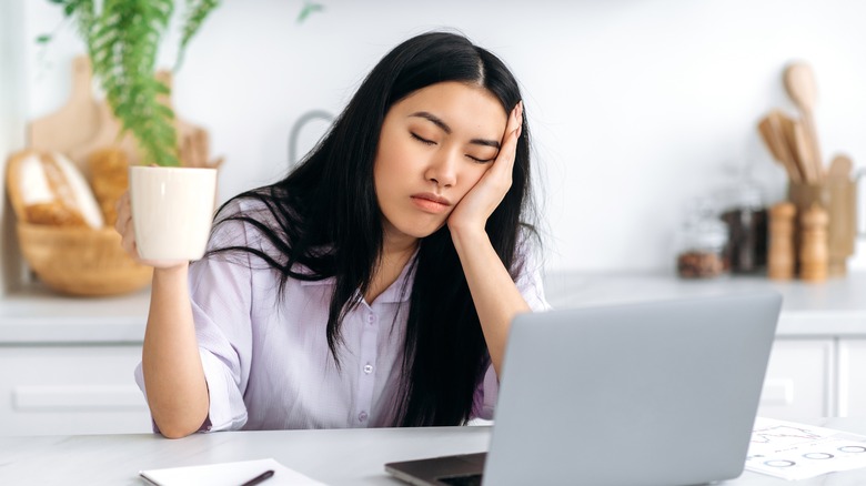 Tired asian woman working from home