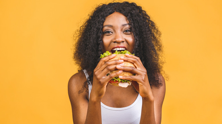 woman eating a hamburger  