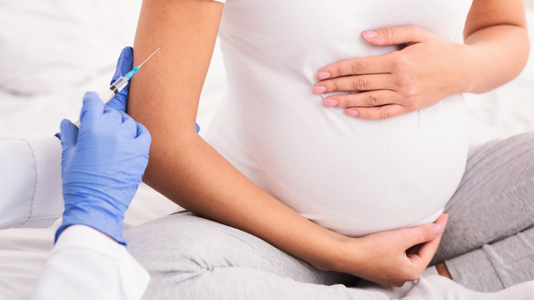 Pregnant person receiving vaccine