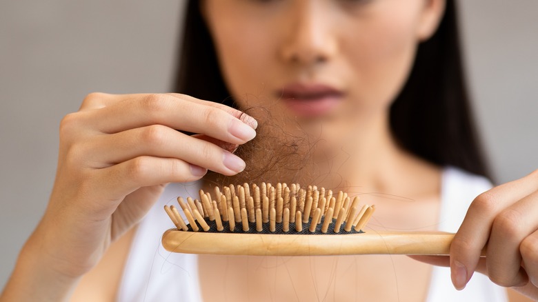 A woman struggles with hair loss