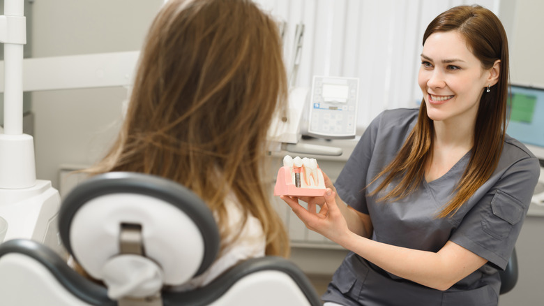 A dentist is talking to a patient about a dental procedure