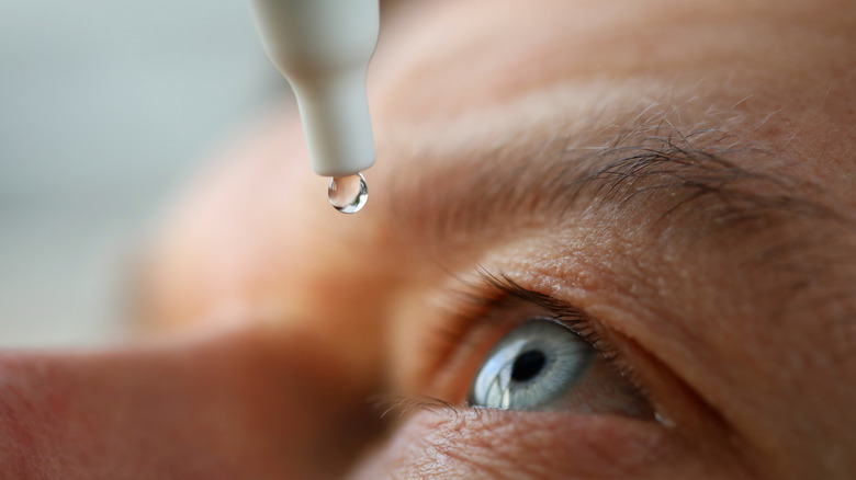 eye drop being dropped into an eye