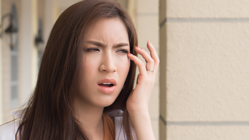 Young woman with irritated eye